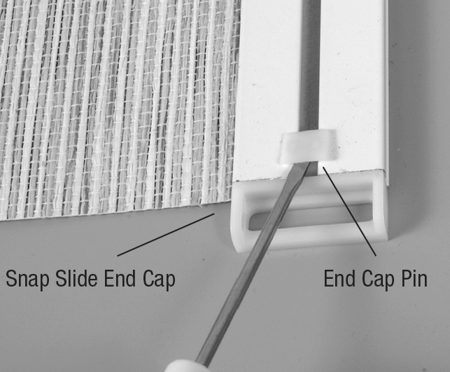 Use a flat-blade screwdriver to remove the end cap pin from the bottom weight.png