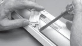 Insert a flathead screwdriver in the gap between the back of the limit assembly and the underside of the headrail.jpg